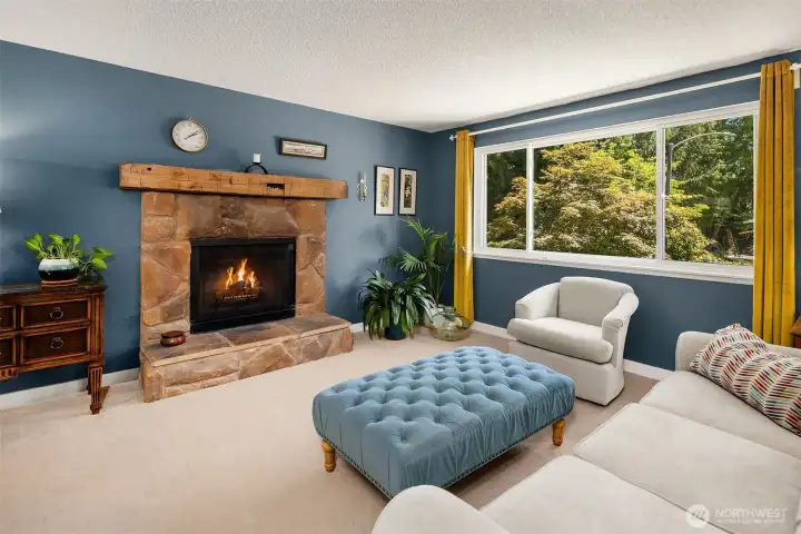 Light-filled living room with wood-burning fireplace.
