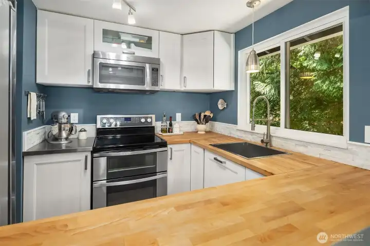 Newer countertops, cabinets and appliances in this compact but well thought out kitchen.