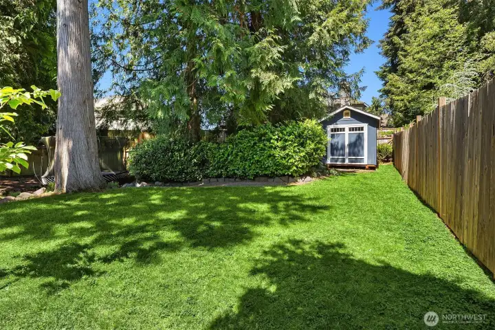 Park-like backyard with garden shed. Lot is almost a 1/4 of an acre