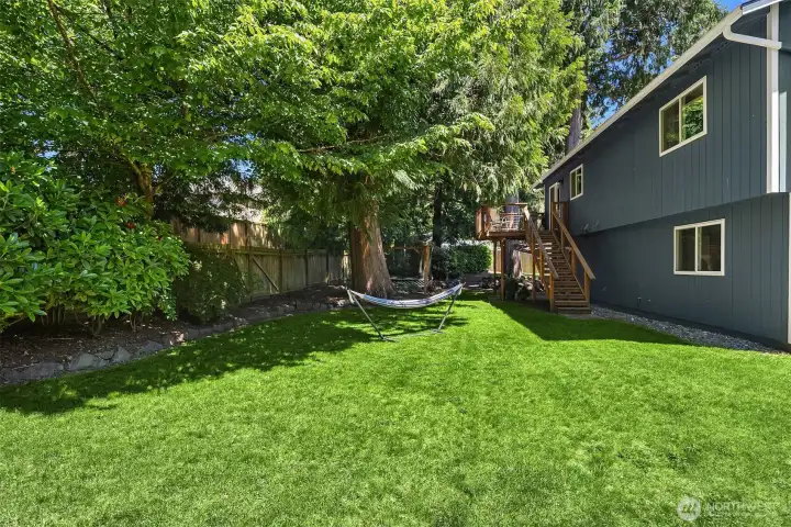 Huge yard with plenty of room for Fido to run and play, or relax and read a book - surrounded by lush landscaping.