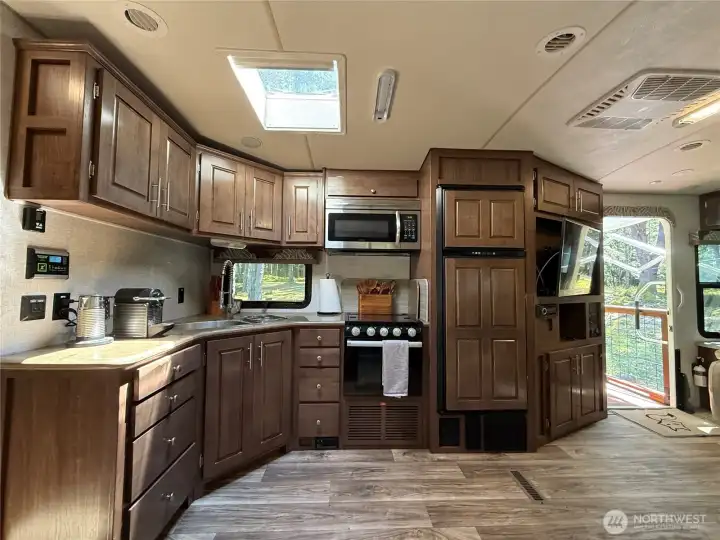 Kitchen with propane stove, refrigerator and microwave Kitchen with propane stove, refrigerator and microwave