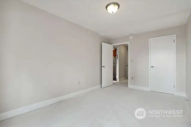 Another view of the bedroom with the closet door on the right.