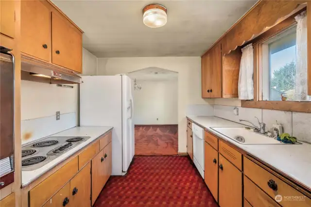 Galley-style kitchen offers efficiency, and the option to remove the wall on the left and open up to the dining and living rooms.