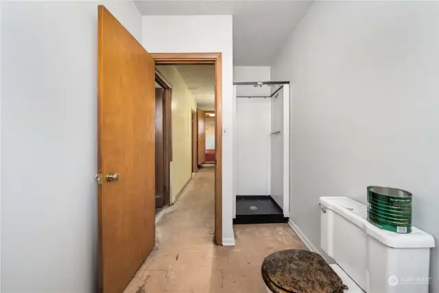 Just past the utility room, at the end of the hall, this bathroom only needs a sink to be a 3/4 bath! Lots of room to add in more storage, as well.