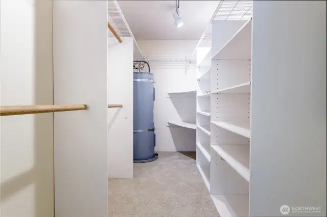 Large walk-in closet with closet system.