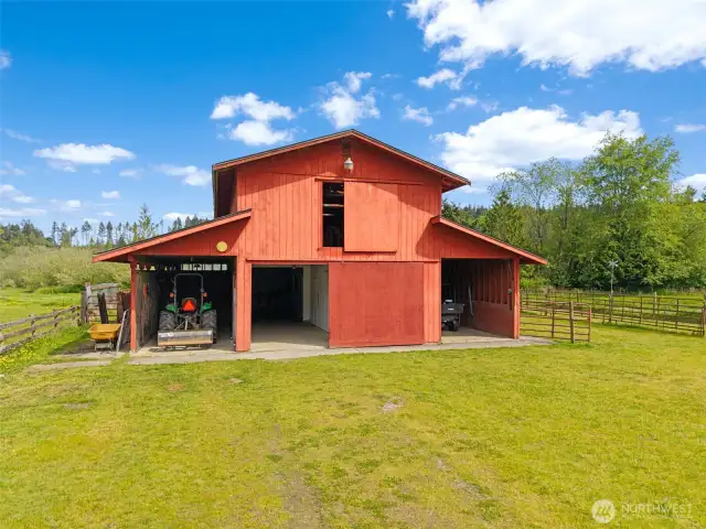 Large stalls, plus a tack room, plus storage, plus a giant hay loft, and open areas for tractors. The perfect quintessential red barn.
