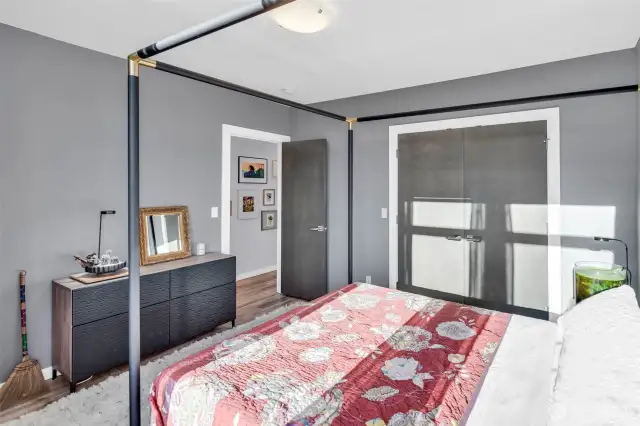 Guest Bedroom #1(four post queen bed shown) with large closets, Southwest facing, super high ceilings and plenty of privacy given it's a stand alone home! Large walk into closet with lighting.