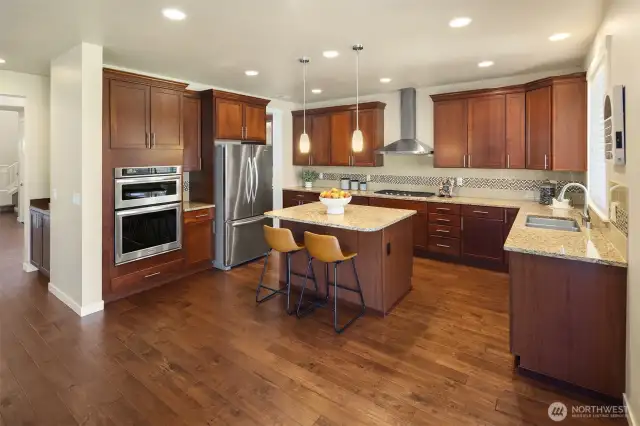 Chef's kitchen with sliders in cabinets, SS appliances and gleaming hardwood floors