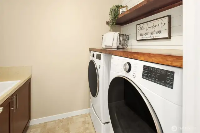 Laundry with built in sink.  Washer/Dryer units stays with the home!
