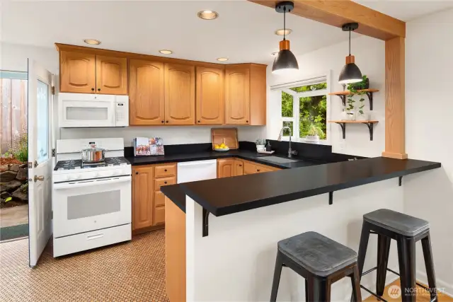 Natural cork flooring provides a softness and warmth against the wood cabinets.