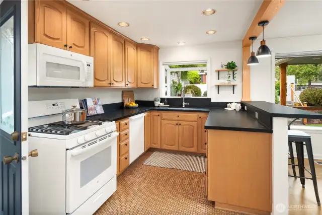 Gas cooking with an overhead microwave features a 5 burner cooktop with griddle.