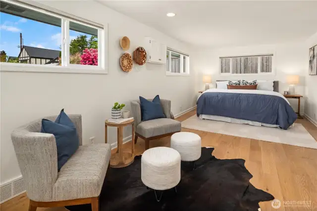 The primary bedroom on the main floor is enormous with fresh paint, new wood floors and 2 wardrobe closets.