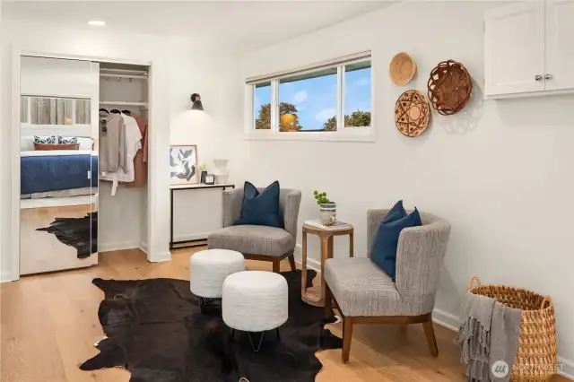 A lighted desk area is off to the right of two separate wardrobe closets for an enviable amount of storage.