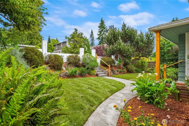 The meticiulously landscaped lot features fresh sod and concrete planters with in-ground irrigation.