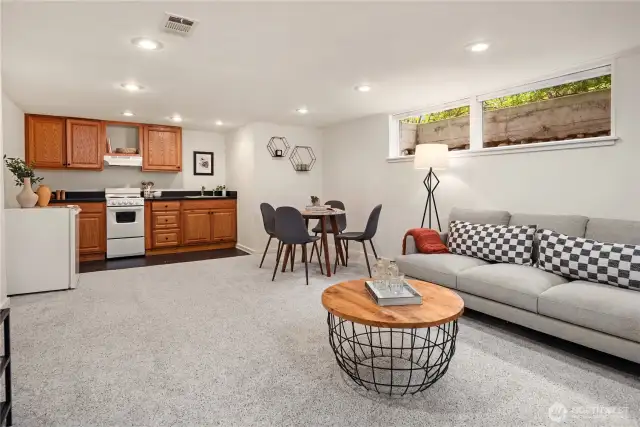 Looking across the rec room towards the kitchenette. The window well looks out towards the front yard.