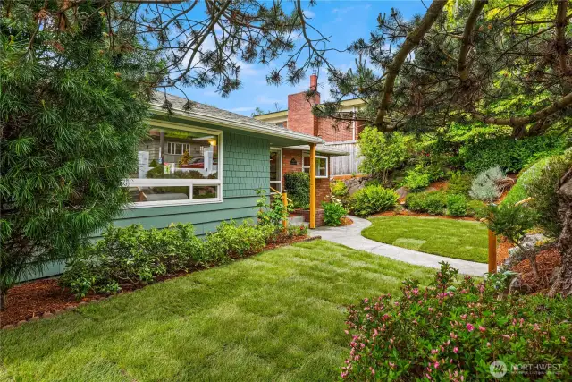 This very private feeling residence boasts a street-to-alley lot with a garage and off-street parking in the back.