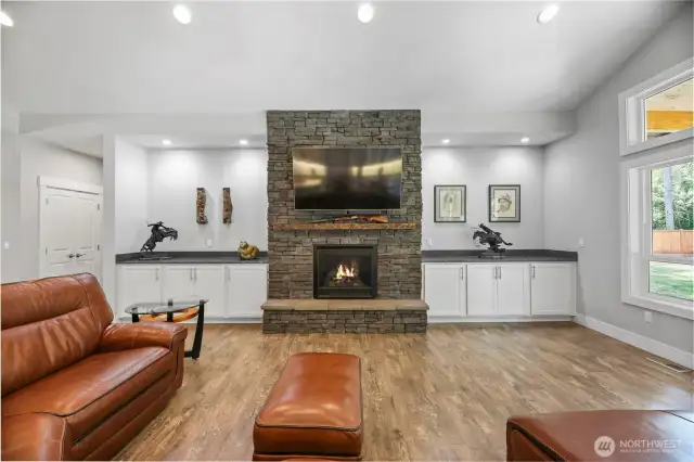 Built ins around the floor to ceiling Rock fireplace