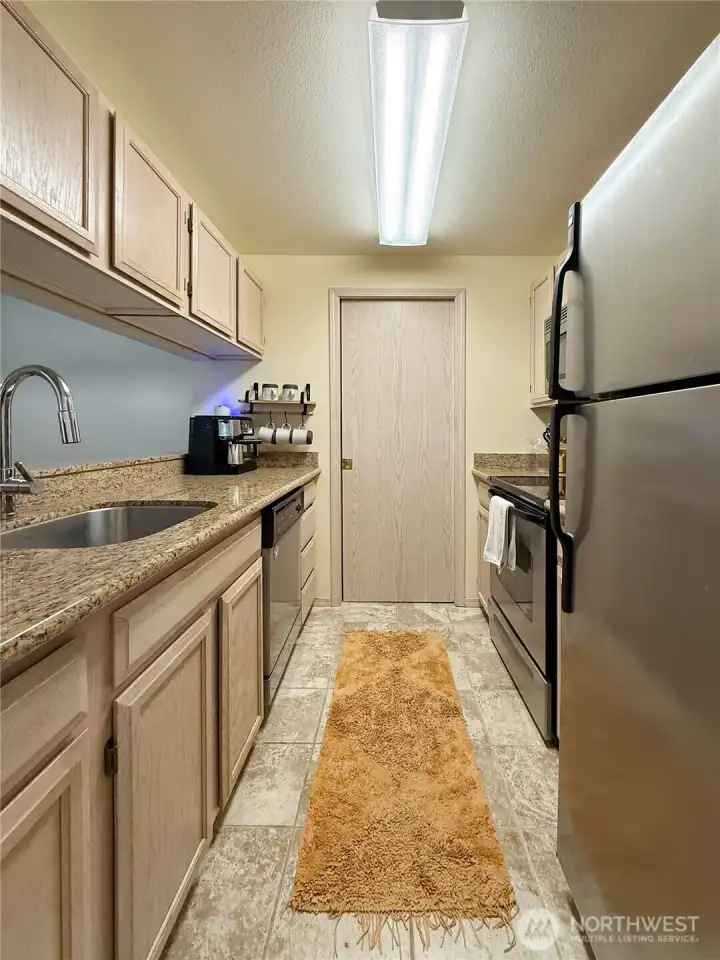 Kitchen facing utility room with washer/dryer