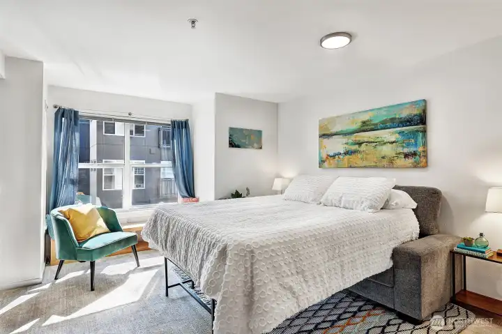 With this configuration, there is space for two bedside tables, plus the Queen sized bed. Also, the window seat and a lounging chair.