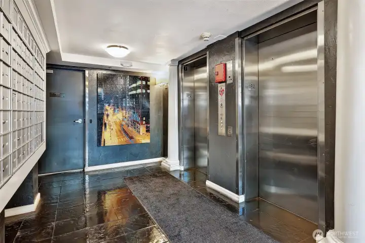 Entry level elevators, art  and mailboxes.
