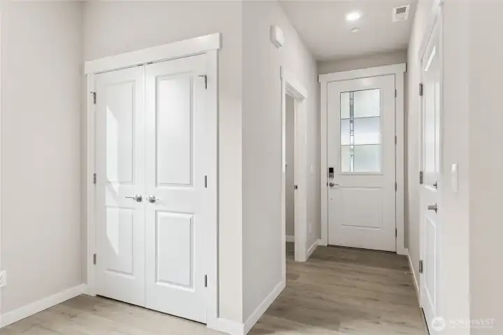 Entry with garage entrance featuring EV charger. Photos are for representational purposes only. Colors and finishes may differ.