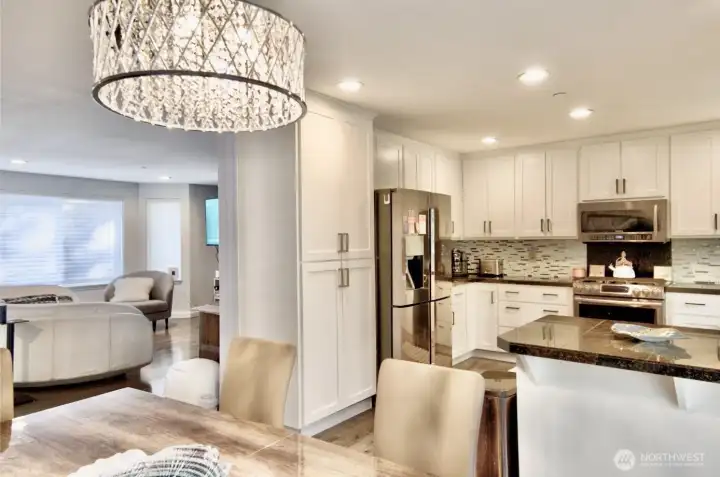 Kitchen open to dining with granite counter top