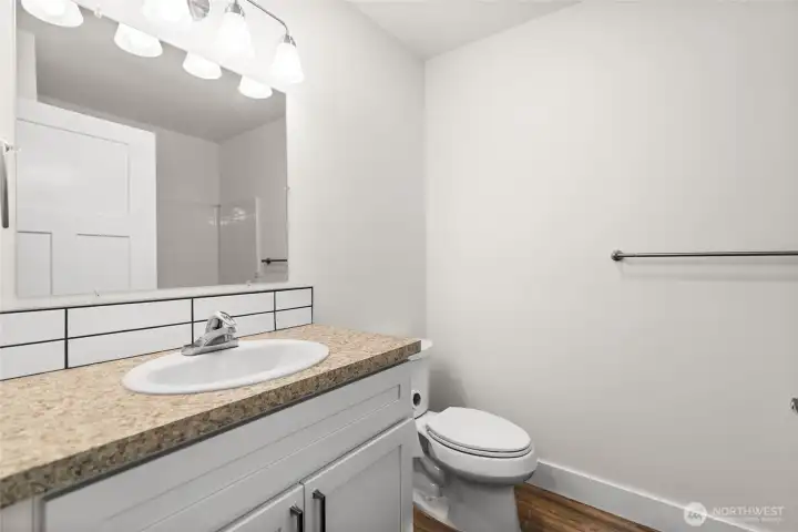 Just to the left of the ground floor bedroom is the first full bath featured in the home!