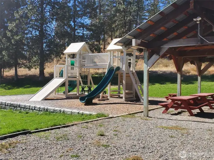 Playground activity jungle gym for the children. Covered picnic table and gathering area.  Ample parking. Large greenbelt grass acreage maintained by the HOA.