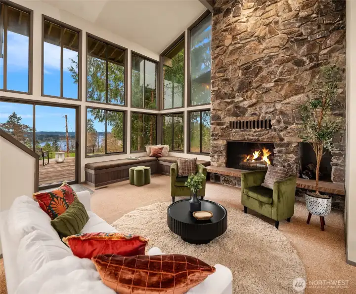 Cozy sunken living room with expansive windows offering abundant natural light and views of the Sound.