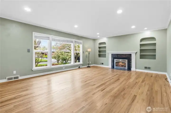 Living room with gas fireplace and built in shelving