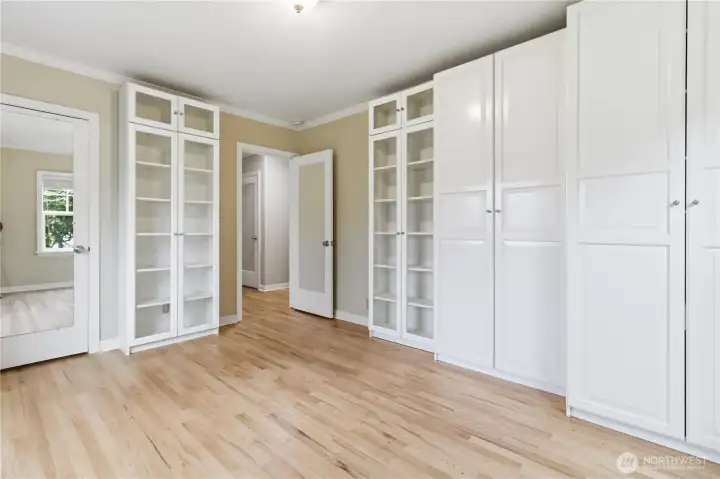 Main level bedroom with closet and cabinet storage
