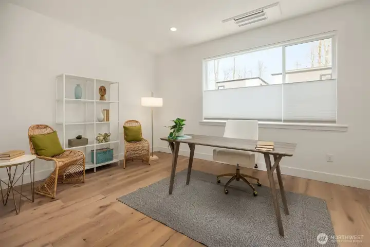 A spacious den with wraparound windows is perfect for a home office or bonus room.