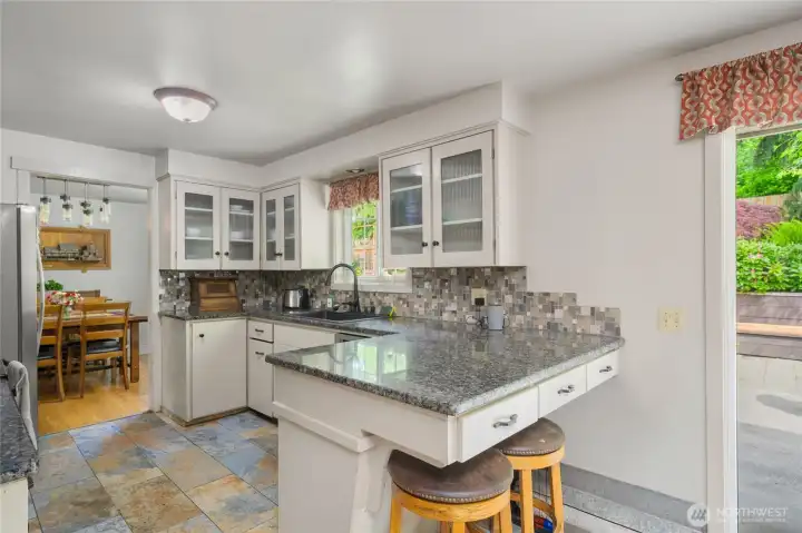Kitchen counter seating near the slider to the phenomenal back yard.