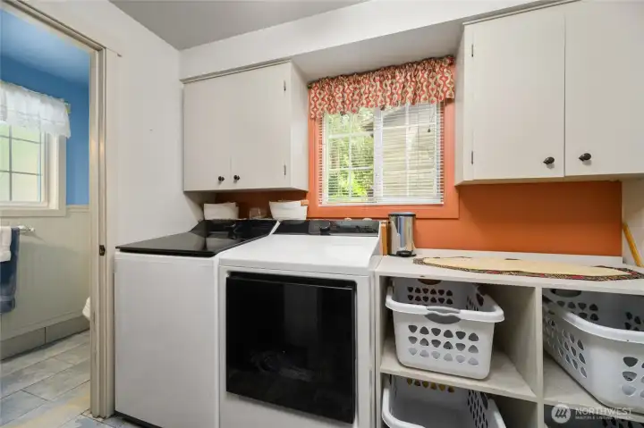 Laundry room with access to the 1/2 bath and garage.