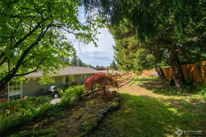 Fully fenced backyard with garden space and extra fire pit.