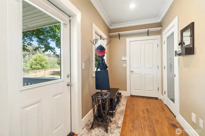 Mudroom. Door at center goes to garage. Pantry door to right. Door to left to access deck and river view. Mudroom. Door at center goes to garage. Pantry door to right. Door to left to access deck and river view.