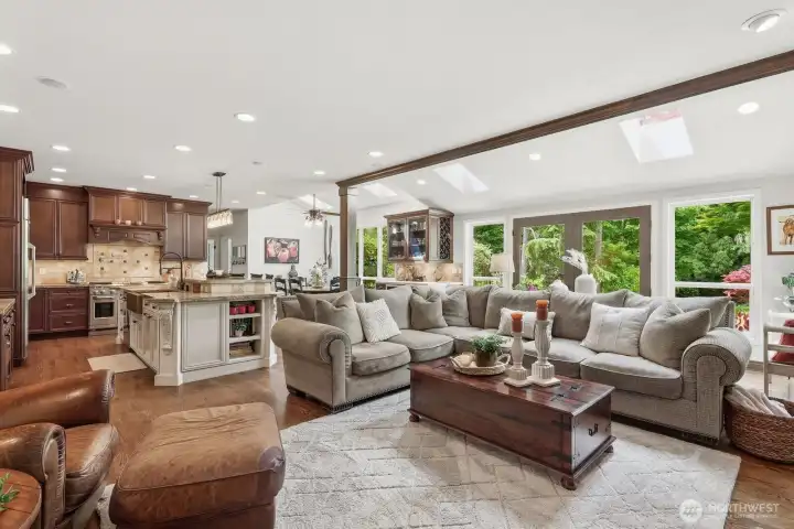 The kitchen flows seamlessly into the spacious informal dining and family room areas, creating an open-concept living environment ideal for modern lifestyles.