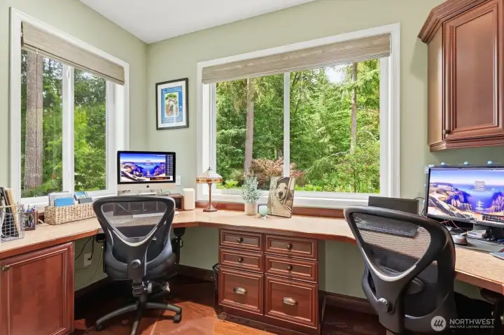 The main floor also features a dedicated home office ideally situated just off the informal dining area. Designed for productivity and flexibility, the office includes custom cherry cabinetry and dual workstations, making it perfect for remote work, studying or managing household activities.