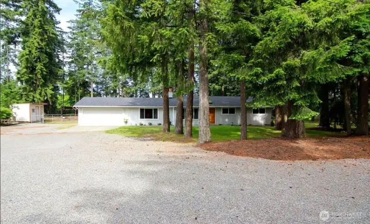 Front of home with side gate to sheds and backyard. Front of home with side gate to sheds and backyard.