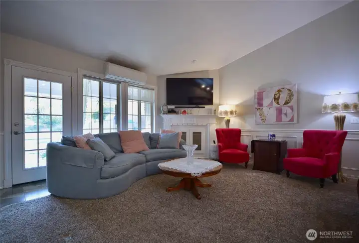 The vaulted ceilings in the living room and kitchen areas add to the feeling of an expansive space. The wainscoting continues throughout this room. The owner had several built ins created for displaying your treasures or for extra storage. Oversized triple skylights brighten the living room and kitchen areas. The back wall is illuminated by an expanse of windows and a door that leads to the covered back porch. The vaulted ceilings in the living room and kitchen areas add to the feeling of an expansive space. The wainscoting continues throughout this room. The owner had several built ins created for displaying your treasures or for extra storage. Oversized triple skylights brighten the living room and kitchen areas. The back wall is illuminated by an expanse of windows and a door that leads to the covered back porch.