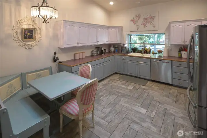 The kitchen has a vaulted ceiling and new porcelain tile floors for easy maintenance. The appliances that come with the home include the stove, fridge, dishwasher and microwave. The kitchen has a vaulted ceiling and new porcelain tile floors for easy maintenance. The appliances that come with the home include the stove, fridge, dishwasher and microwave.