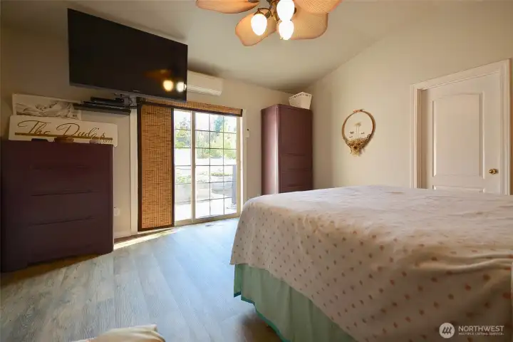 The nice sized main bedroom has vinyl plank floors. The French door on the back wall leads to a private patio exclusively for this room. There's a large walk in close that is equipped with a shelving system for storage. The nice sized main bedroom has vinyl plank floors. The French door on the back wall leads to a private patio exclusively for this room. There's a large walk in close that is equipped with a shelving system for storage.