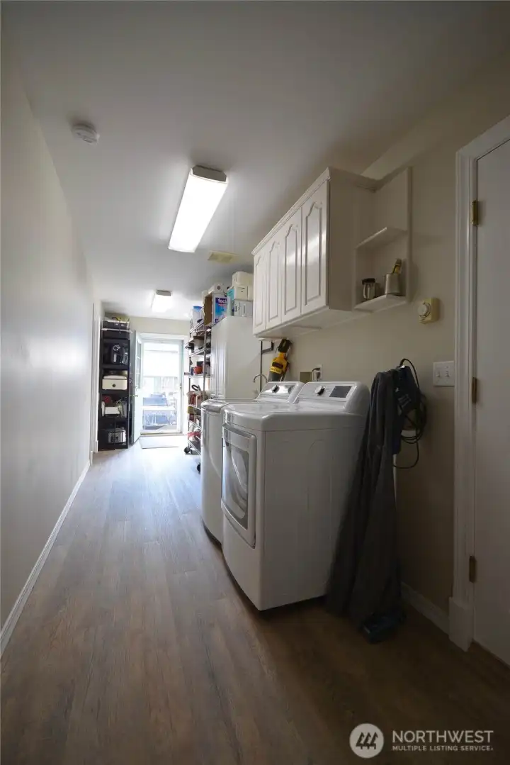 The laundry area has vinyl plank flooring. IT offers lots of storage space. Doors lead to the attached garage and a man door to the pool area on the far end of the room. The attached 2 car garage measures 624 sq ft. Walls of built in storage allow space for all your needs. Bonus: the attic space has more room for storage and is accessed by drop down stairs. The laundry area has vinyl plank flooring. IT offers lots of storage space. Doors lead to the attached garage and a man door to the pool area on the far end of the room. The attached 2 car garage measures 624 sq ft. Walls of built in storage allow space for all your needs. Bonus: the attic space has more room for storage and is accessed by drop down stairs.