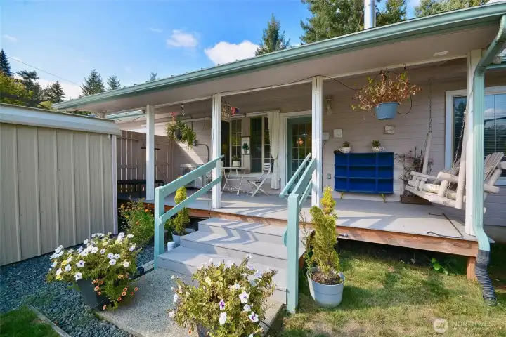 The second covered porch at the back of the home is right off the living room. Lots of space for outdoor dining, an area for lounging and an old fashioned country swing of course. An ooutbuilding at the bottom of the steps provides a place for you lawn equipment and garden tools. The second covered porch at the back of the home is right off the living room. Lots of space for outdoor dining, an area for lounging and an old fashioned country swing of course. An ooutbuilding at the bottom of the steps provides a place for you lawn equipment and garden tools.