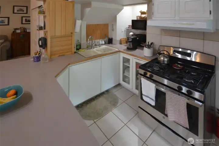 A delightful and functionial kitchen has tile flooring. A delightful and functionial kitchen has tile flooring.