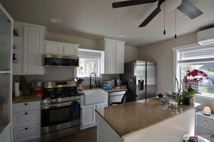 All the floors are vinyl plank. In the kitchen area the counters are granite, as well as the large granite topped island. The cabinetry is upgraded and theres a farm sink too. All the floors are vinyl plank. In the kitchen area the counters are granite, as well as the large granite topped island. The cabinetry is upgraded and theres a farm sink too.