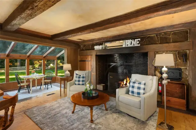 Relax by the enormous walk-in style wood burning fireplace in the cozy kitchen/family room. This is such a gorgeous great room where everyone wants to gather. Check out the gorgeous reclaimed old growth timber beams. They are absolutely priceless.