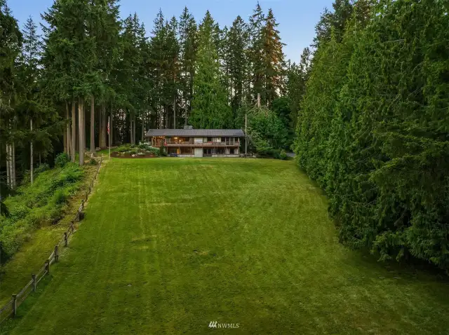 Vast rolling grounds, lush, grassy fields and acres of old growth timber. A private paradise just minutes away from everything!!!