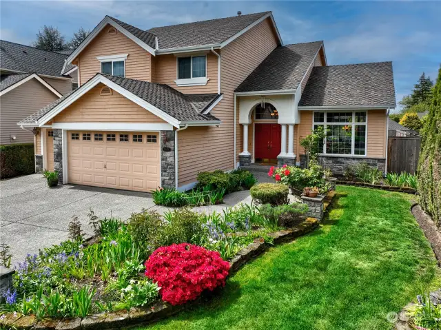 Such an inviting front yard & walkway with lots of garden space.