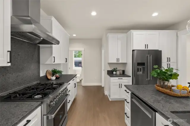 Classic kitchen with white cabinets, granite counters, stainless appliances and large kitchen island